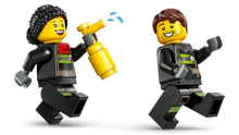 Load image into Gallery viewer, Two LEGO minifigures from the LEGO City Fire Truck set 60463, one holding a fire extinguisher