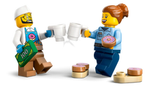 Load image into Gallery viewer, LEGO City Donut Truck minifigures clinking coffee mugs with donuts and money from Brick Shack boxed set

