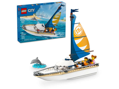LEGO City sailboat set with white and blue sail, three minifigures, and a dolphin figure in water