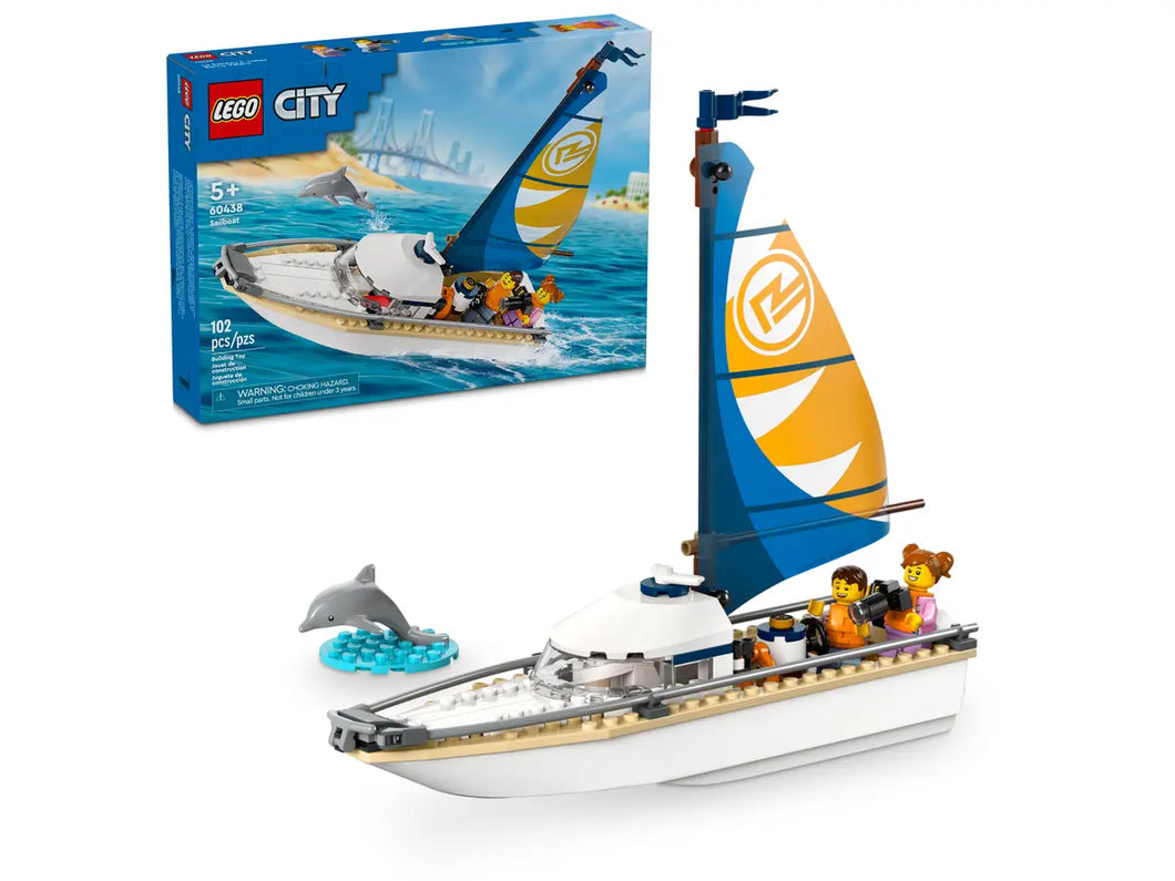 LEGO City sailboat set with white and blue sail, three minifigures, and a dolphin figure in water