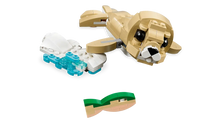 Load image into Gallery viewer, LEGO Creator 3 in 1 Cute Bunny build featuring a tan sea lion swimming with fish on black background
