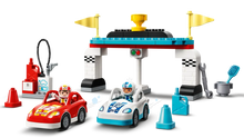Load image into Gallery viewer, LEGO DUPLO race cars set 10947 featuring two race cars, pit stop, and accessories for kids
