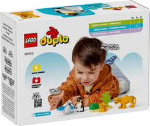 Load image into Gallery viewer, LEGO Duplo Wild Animal Families 10442 set with a child playing with animal figures and accessories
