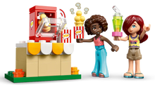 Load image into Gallery viewer, LEGO Friends Friendship Movie Night set 42642 featuring two characters with popcorn and drinks by a snack stand
