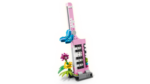 LEGO typewriter set with flowers in pink and blue by Brick Shack displayed on black background